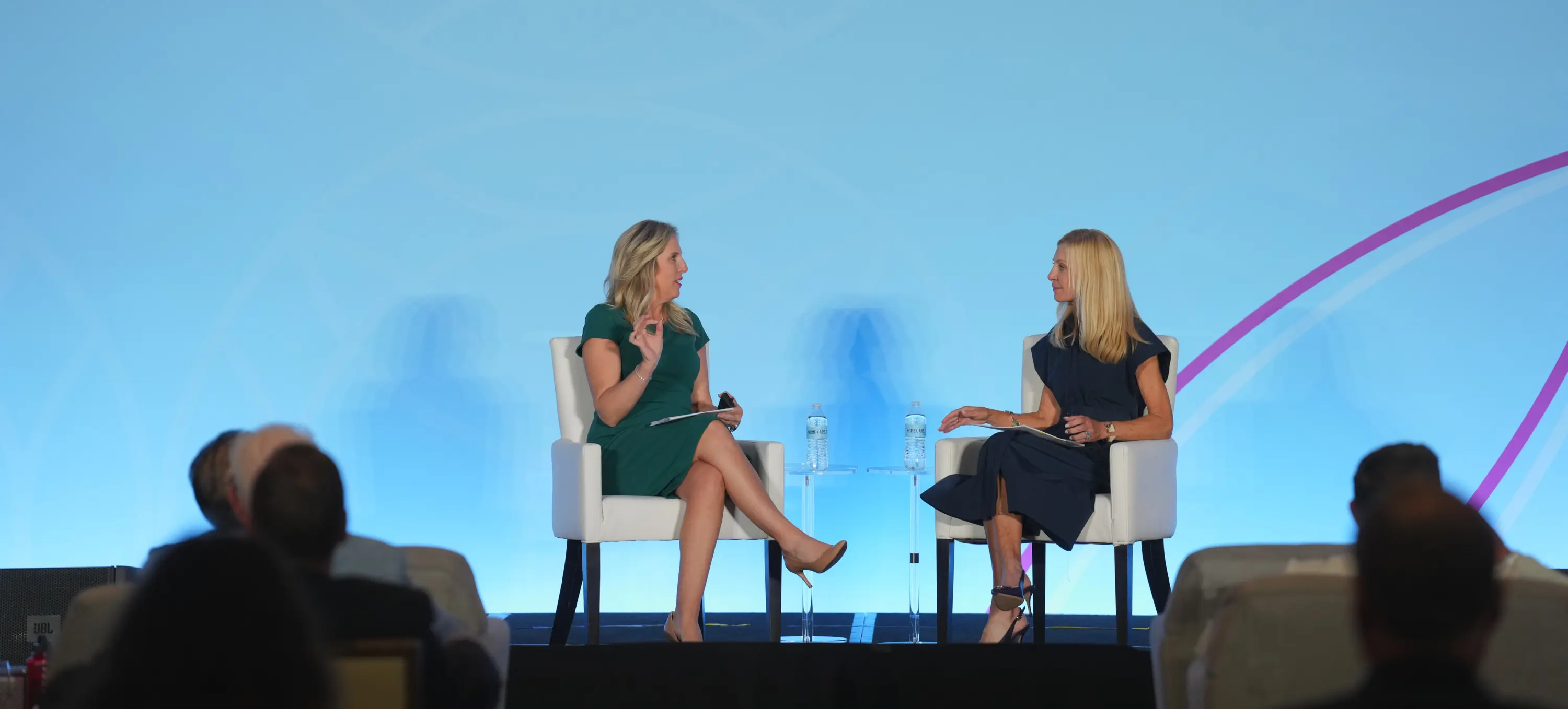 Two senior care leaders in conversation on stage at a Lincoln Healthcare Leadership event
